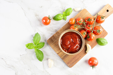 Tomato paste, sauce, ketchup and cherry tomatoes on branches and basil