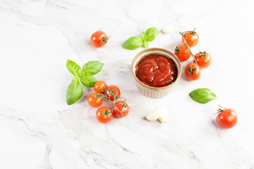 Tomato paste, sauce, ketchup and cherry tomatoes on branches and basil