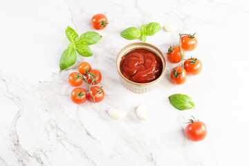 Tomato paste, sauce, ketchup and cherry tomatoes on branches and basil