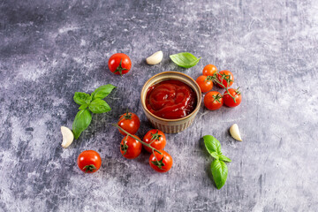 Tomato paste, sauce, ketchup and cherry tomatoes on branches and basil