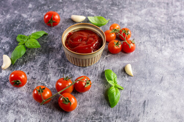 Tomato paste, sauce, ketchup and cherry tomatoes on branches and basil