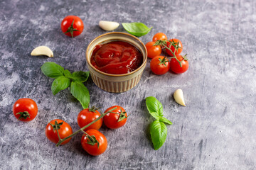 Tomato paste, sauce, ketchup and cherry tomatoes on branches and basil