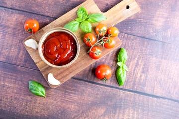 Tomato paste, sauce, ketchup and cherry tomatoes on branches and basil