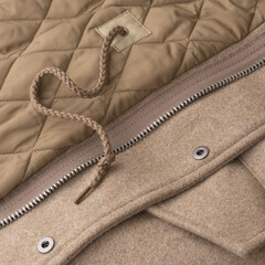 Close-up of interior details of a light beige wool coat