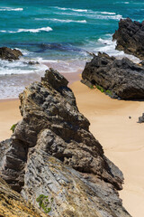 Atlantic ocean coastline with rocks, light sand and turquoise water