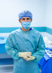 Surgeon ready for procedure. A medical professional is readying themselves in a surgical...