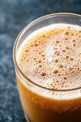 Golden brown beverage with frothy surface, elegantly captured in
