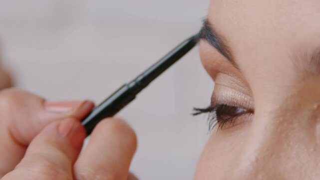 A detailed closeup of hands actively engaging in the artistic application of makeup