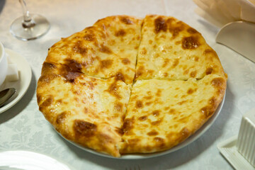 Traditional georgian food khachapuri with brynza cheese on a table