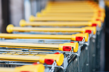 Yellow-Handled Shopping Carts with Coin Deposit Mechanism