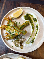 Zucchini flowers with white and green sauce.