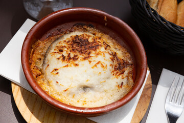 Eggplant with minced meat baked with cheese, moussaka dish in pot