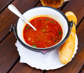 Spicy Mexican bean soup (fazolova polevka) served with fresh bread in czech restaurant..
