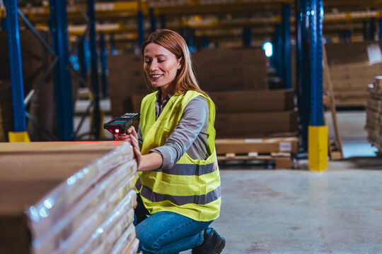 Worker Scanning Packages in a Distribution Warehouse Setting