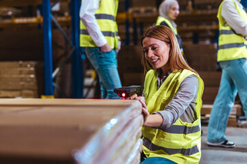 Female Warehouse Worker Scanning Packages in a Distribution Center