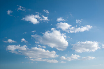 Fototapeta premium Vast blue sky with scattered fluffy white clouds