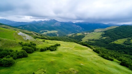 Naklejka premium Open green landscape with rolling hills and mountains under a cloudy sky showcasing nature's beauty : Generative AI