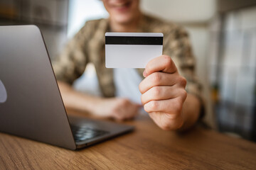 close up on man hands hold credit card ready for online shopping