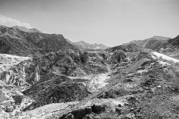 A desolate landscape with mountains in the background