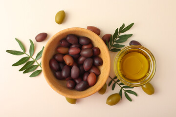 A premium olive oil with olives and fresh leaves, top view 