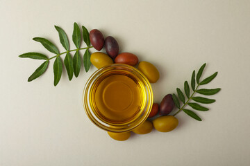 A premium olive oil with olives and fresh leaves, top view 