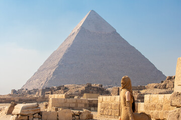Back view of woman looking at Great Pyramids of Chephren and Cheops, Cairo, Egypt. Two of the three Great Pyramids, Giza pyramid complex (Giza Necropolis)