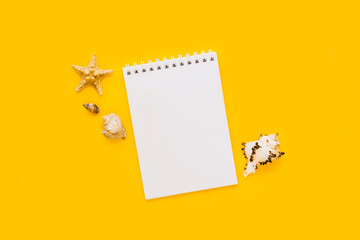 To do list or blank notebook with set of starfish, sea shell on yellow background. Travel, summer...
