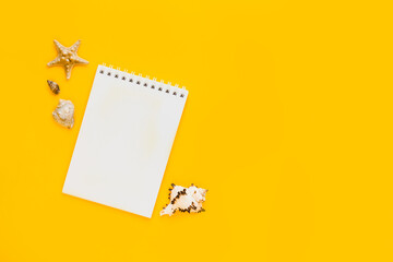 To do list or blank notebook with set of starfish, sea shell on yellow background. Travel, summer...