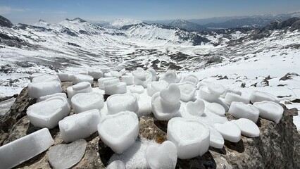 winter texture of mountains, heart shapes made of snow, longing for mountains, affection and love