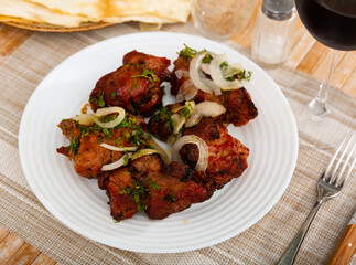 Traditional oriental grilled pork meat shashlik served with onion and lavash