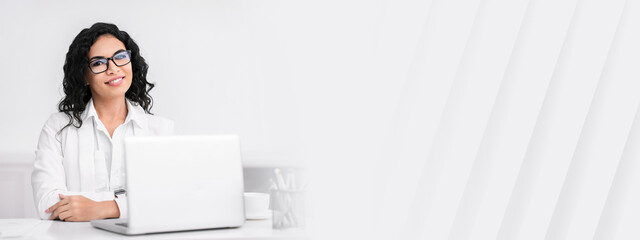 Successful Businesswoman. Portrait of confident mexican lady sitting at desk, looking at camera, copy space