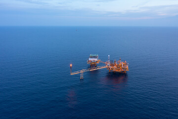Central processing platform (cpp) in the middle of the ocean during sunset time - upstream industry.