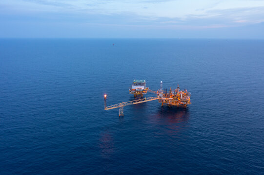 Central processing platform (cpp) in the middle of the ocean during sunset time - upstream industry.
