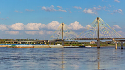 Scenic view of the Clark Bridge across the Mississippi River from Missouri to Illinois with a barge passing beneath it