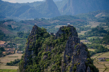Fototapeta premium Twin Limestone Peaks with Scenic Viewing Platforms Surrounded by Farmlands and Rolling Hills in Vang Vieng, Laos