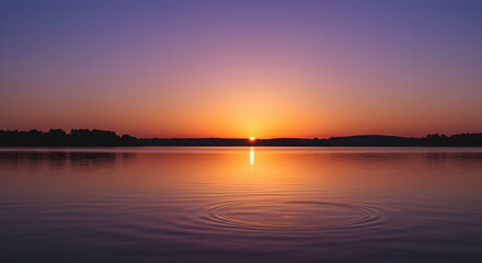 Sunset Over Calm Lake Water with Gentle Ripples and Colorful Sky