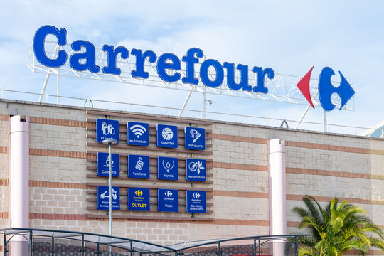 Dos Hermanas, Seville, Spain, 02-15-2025; Exterior view of a Carrefour supermarket with logo sign on facade.