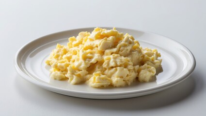 Homemade tasty scrambled eggs on a white plate, white background medium shot.