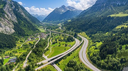 Fototapeta premium A well-paved mountain highway snaking through a valley of green trees and dense forest