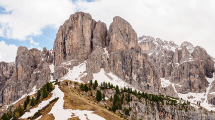Majestic mountain peaks in scenic landscape with snow and pine trees near Valley of Funes at Dolomites, Italy.
