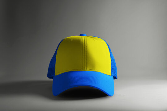 image of a mock up trucker hat design in a plain combination of Blue and Yellow on a isolated background.