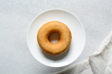 Overhead view of fresh donuts on a white background, top view of homemade doughnuts, process of making doughnuts