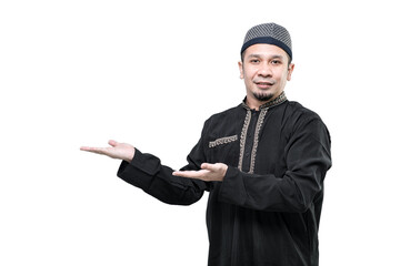Asian Arabic Muslim man showing present something over his empty hand and pointing, isolated in a white background, Business, Ramadan.