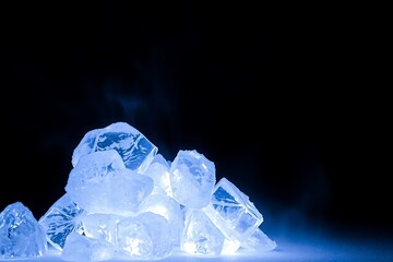 Pile Of Ice Cubes Illuminated By Cool Blue Light Against Dark Background