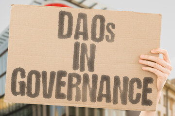 "DAOs in Governance" on worn cardboard. Highlights the growing role of DAOs in managing public services. RESOURCES. MANAGEMENT. AUTONOMY. TRANSPARENCY. CONSENSUS. DECENTRALIZATION