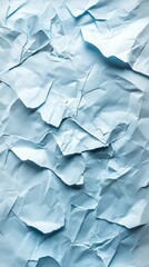 Fototapeta premium Abstract composition of crumpled light blue paper, creating texture and visual interest with shadows.