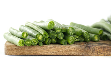 Fresh cut green beans on wooden cutting board