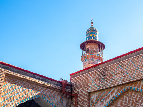 The Blue Mosque in Yerevan, Armenia. beautiful buildings, tower, brick wall construction with art patterns mosaic details decorations, on blue sky background.