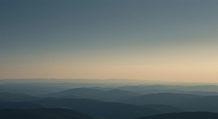 Aerial view of hazy mountain range at golden hour light