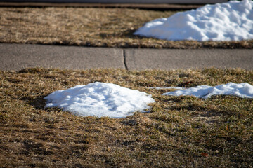 Piles of snow in the yard during spring